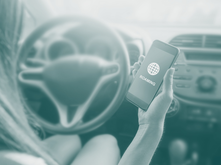 Woman in car holding mobile phone