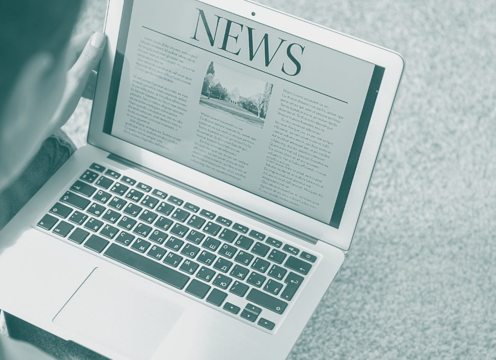 Man reading news on laptop