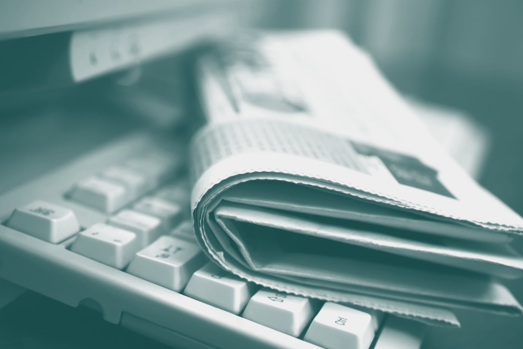 Newspaper resting on computer keyboard